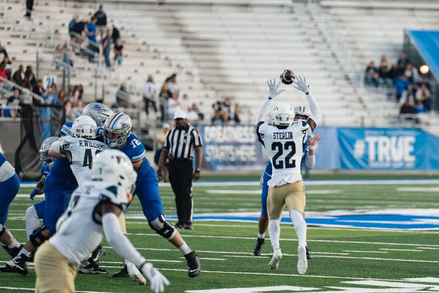 WJ Lee, sports photographer, reviewing game-day shots